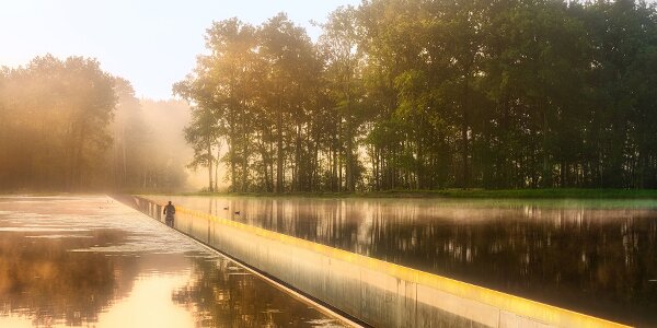 Cyclist in the early morning on 'Cycling through Water' in Bokrijk